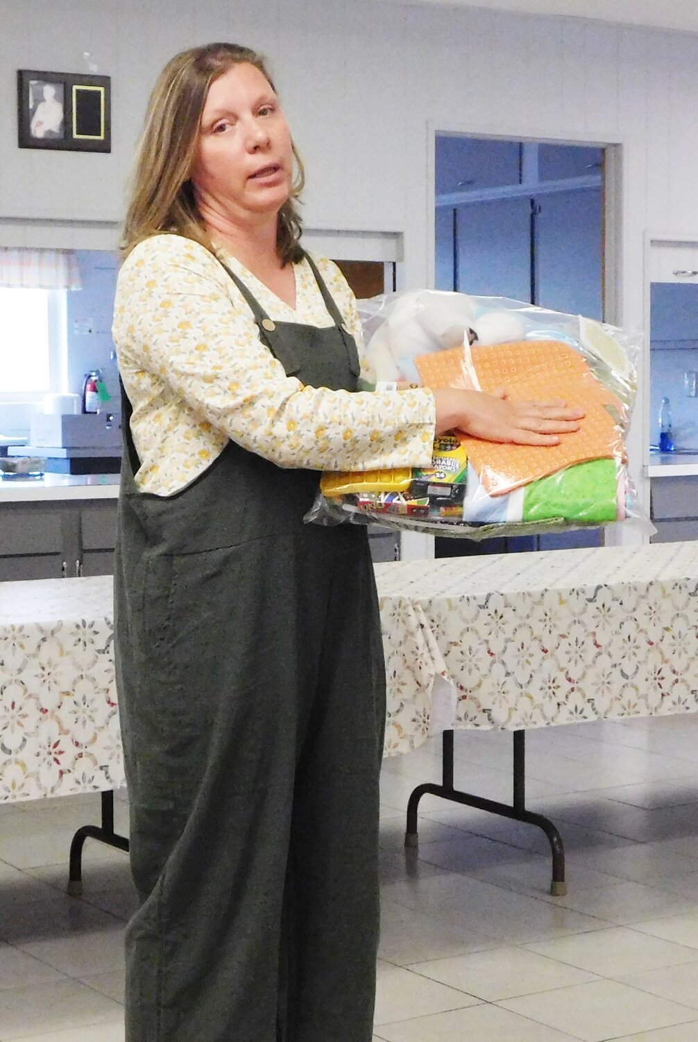 Keri Withers displays one of the packs assembled by her organization and distributed to children who are placed into foster care. Those packs include personal care items along with quilts sewn by the many volunteers who donate their time and skills to benefit the children.